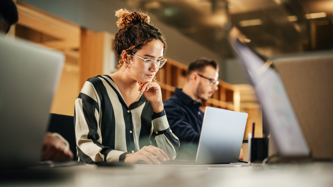 person learning how to use ai in hr on their laptop computer in an office.