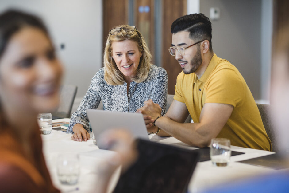 Feature image colleagues looking into why hr benchmarking is so important